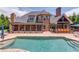 Spacious home exterior featuring a pool, screened-in porch, outdoor grill, and patio area at 120 Slate Dr, Buford, GA 30518
