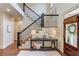 Stylish entryway with a staircase, console table, and decorative accents, creating a grand and inviting first impression at 120 Slate Dr, Buford, GA 30518