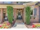 Inviting front porch with stone columns, lush greenery, and a beautifully decorated door, creating a warm welcome at 120 Slate Dr, Buford, GA 30518