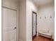 Inviting hallway with shiplap accent wall, pantry access, and stylish bench seating at 120 Slate Dr, Buford, GA 30518