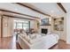 Bright living room features wooden beams, fireplace, built-in shelves, and glass doors to the patio at 120 Slate Dr, Buford, GA 30518