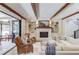 Comfortable living room features a fireplace, built-in shelves, hardwood floors and access to the patio at 120 Slate Dr, Buford, GA 30518