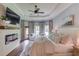 Spacious main bedroom featuring a modern fireplace, tray ceiling, sitting area, and plenty of natural light at 120 Slate Dr, Buford, GA 30518