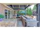 This outdoor kitchen includes a grill, pizza oven, and bar seating perfect for entertaining at 120 Slate Dr, Buford, GA 30518
