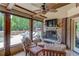 The screened-in patio shows outdoor seating, a fireplace, and a lovely view of the pool at 120 Slate Dr, Buford, GA 30518