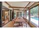 The screened-in patio showcases an outdoor dining area, stylish décor, and beautiful lighting at 120 Slate Dr, Buford, GA 30518