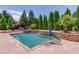 Stunning swimming pool with stone accents and lush landscaping creates a relaxing outdoor oasis at 120 Slate Dr, Buford, GA 30518