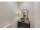 Elegant powder room with shiplap, vintage mirror, and decor creating a charming space at 120 Slate Dr, Buford, GA 30518
