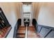 The staircase offers dark wood trim, stylish decor, and natural light at 120 Slate Dr, Buford, GA 30518