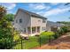 Lovely backyard features a well-maintained lawn, patio seating, and secure black metal fencing at 4583 Grenadine Cir, Acworth, GA 30101