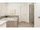 Primary bathroom features soaking tub with tiled surround, shower and towel rack at 4583 Grenadine Cir, Acworth, GA 30101