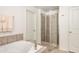 Bathroom featuring a glass-enclosed shower, neutral tile, and a pristine white door and trim at 4583 Grenadine Cir, Acworth, GA 30101