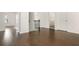 Hallway features wood floors, staircase, and doorway views to bathroom and bedroom at 4583 Grenadine Cir, Acworth, GA 30101