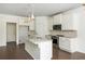 Spacious kitchen boasts white cabinets, an island with sink, and stainless steel appliances at 4583 Grenadine Cir, Acworth, GA 30101