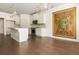 Modern kitchen next to dining area with island, stainless appliances, and hardwood floors at 4583 Grenadine Cir, Acworth, GA 30101