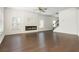 Open living room with modern fireplace, hardwood floors, and staircase at 4583 Grenadine Cir, Acworth, GA 30101