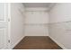 A walk-in closet featuring hardwood floors, white walls, and built-in shelving at 4583 Grenadine Cir, Acworth, GA 30101
