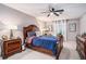 Spacious bedroom with a ceiling fan and a large window, featuring a comfortable bed and matching dressers at 46 Le Parc Fontaine, Lithonia, GA 30038
