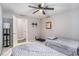 Functional bedroom with twin beds, ceiling fan, mounted TV, and easy access to an adjoining room at 46 Le Parc Fontaine, Lithonia, GA 30038
