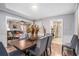 Dining room featuring grey walls, six chairs, hardwood floors, and access to living room and kitchen at 46 Le Parc Fontaine, Lithonia, GA 30038