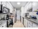 Well-lit kitchen featuring white cabinets, stainless steel appliances, and granite countertops at 46 Le Parc Fontaine, Lithonia, GA 30038