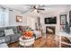 Open-concept living area with fireplace, hardwood floors, grey sectional, and bright decor at 46 Le Parc Fontaine, Lithonia, GA 30038