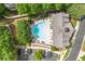 Aerial view of a community pool surrounded by trees and parking lots at 5534 Parkerton Ln, Atlanta, GA 30342