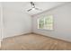 Bright bedroom with neutral carpet, ceiling fan, and a window for natural light at 5534 Parkerton Ln, Atlanta, GA 30342