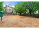 Community dog park featuring wood chip ground cover, black metal fencing, mature trees, and a bench at 5534 Parkerton Ln, Atlanta, GA 30342