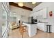Bright kitchen with white cabinets, black countertops, stainless steel appliances and a cozy breakfast bar area at 5534 Parkerton Ln, Atlanta, GA 30342