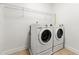 Functional laundry room with modern washer and dryer units, plus wire shelving at 5534 Parkerton Ln, Atlanta, GA 30342