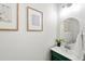 Stylish powder room with green vanity, modern mirror and decor at 5534 Parkerton Ln, Atlanta, GA 30342