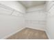 Spacious walk-in closet featuring carpeted floors and wire shelving for optimal storage solutions at 5534 Parkerton Ln, Atlanta, GA 30342
