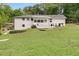 Rear exterior view of white home with sprawling backyard at 1083 Amelia Sw Dr, Marietta, GA 30060