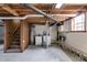 Unfinished basement with exposed wood beams and laundry hookups at 1083 Amelia Sw Dr, Marietta, GA 30060