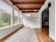 Bright sunroom with wood ceiling, hardwood floors, and large windows overlooking backyard at 1083 Amelia Sw Dr, Marietta, GA 30060