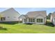 A view of a well-maintained backyard of a white home with a covered patio at 1629 Tielman Way, Snellville, GA 30078