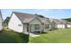 A view of several well-maintained backyards of white homes with covered patios at 1629 Tielman Way, Snellville, GA 30078