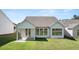 A view of a well-maintained backyard of a white home with a covered patio at 1629 Tielman Way, Snellville, GA 30078