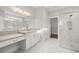 Elegant bathroom featuring marble floors, walk-in shower, and vanity with ample counter space at 1629 Tielman Way, Snellville, GA 30078