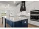 Island kitchen with modern pendant lighting and a large sink creates a focal point in this space at 1629 Tielman Way, Snellville, GA 30078