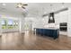 Spacious kitchen features a large island, white cabinets, stainless steel appliances, and hardwood floors at 1629 Tielman Way, Snellville, GA 30078