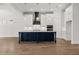 Modern kitchen with a central island, white cabinetry, stainless steel appliances, and pendant lighting at 1629 Tielman Way, Snellville, GA 30078