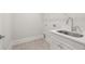 Laundry room with quartz countertop, shaker cabinets, stainless steel sink at 1629 Tielman Way, Snellville, GA 30078