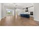 Open-concept living area featuring hardwood floors, a modern kitchen with stainless steel appliances, and bright natural light at 1629 Tielman Way, Snellville, GA 30078