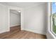 Unfurnished room with hardwood floors, a window, and white trim at 1629 Tielman Way, Snellville, GA 30078