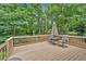 Backyard featuring a wooden deck with outdoor seating surrounded by lush trees and greenery at 328 West Ln, Woodstock, GA 30188