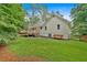 Backyard featuring a deck, fence, and plenty of green space for outdoor activities at 328 West Ln, Woodstock, GA 30188