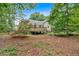 Inviting backyard featuring a spacious wooden deck and a lush, tree-lined perimeter at 328 West Ln, Woodstock, GA 30188