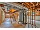 Unfinished basement with exposed ceiling, utilities, and stairs leading to the upper level at 328 West Ln, Woodstock, GA 30188